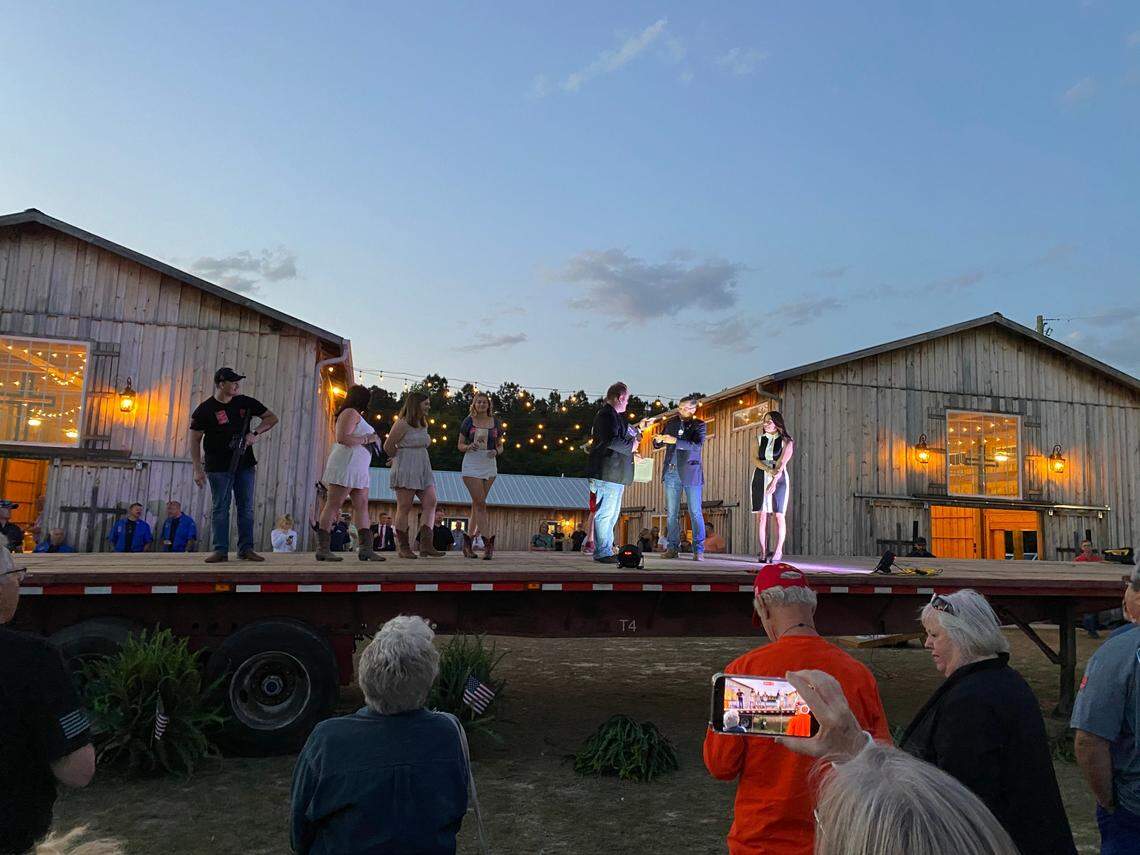 Former National Security Advisor Gen. Michael Flynn helps conservative activist Chad Caton and Republican operative and investigative journalist Tracy “Beanz” Diaz raffle off prizes at an event meant to garner support for new leaders of the Horry County Republican Party.
