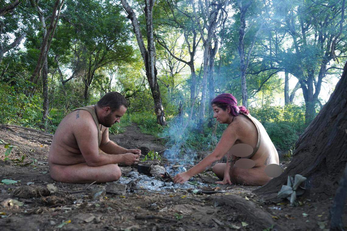 Nicole Pisani, and her male counterpart, Andrew, sit at their campfire on the reality TV show “Naked and Afraid.”