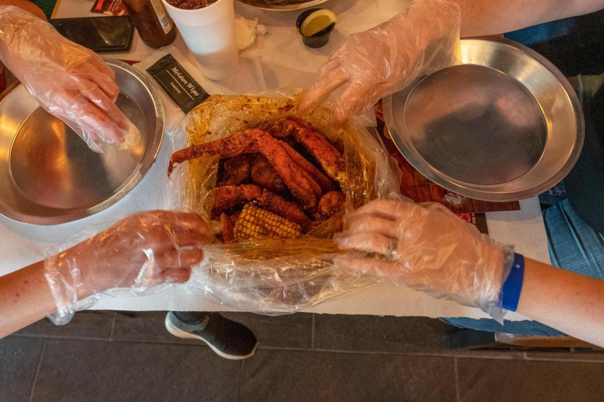 Mr. Crab, a seafood restaurant specializing in crab and seafood boils, opened this month in North Myrtle Beach, S.C. The boils are delivered in a steaming sealed bag and diners use bibs and gloves to eat over a covered table. March 17, 2021.