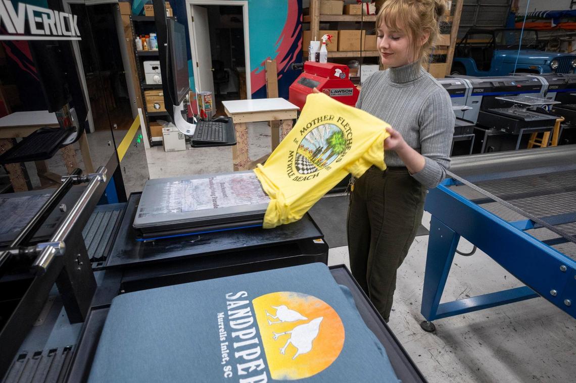 Kelly Barwick prints vintage T-shirt designs at Native Sons in Myrtle Beach, S.C. Dec. 13, 2023.