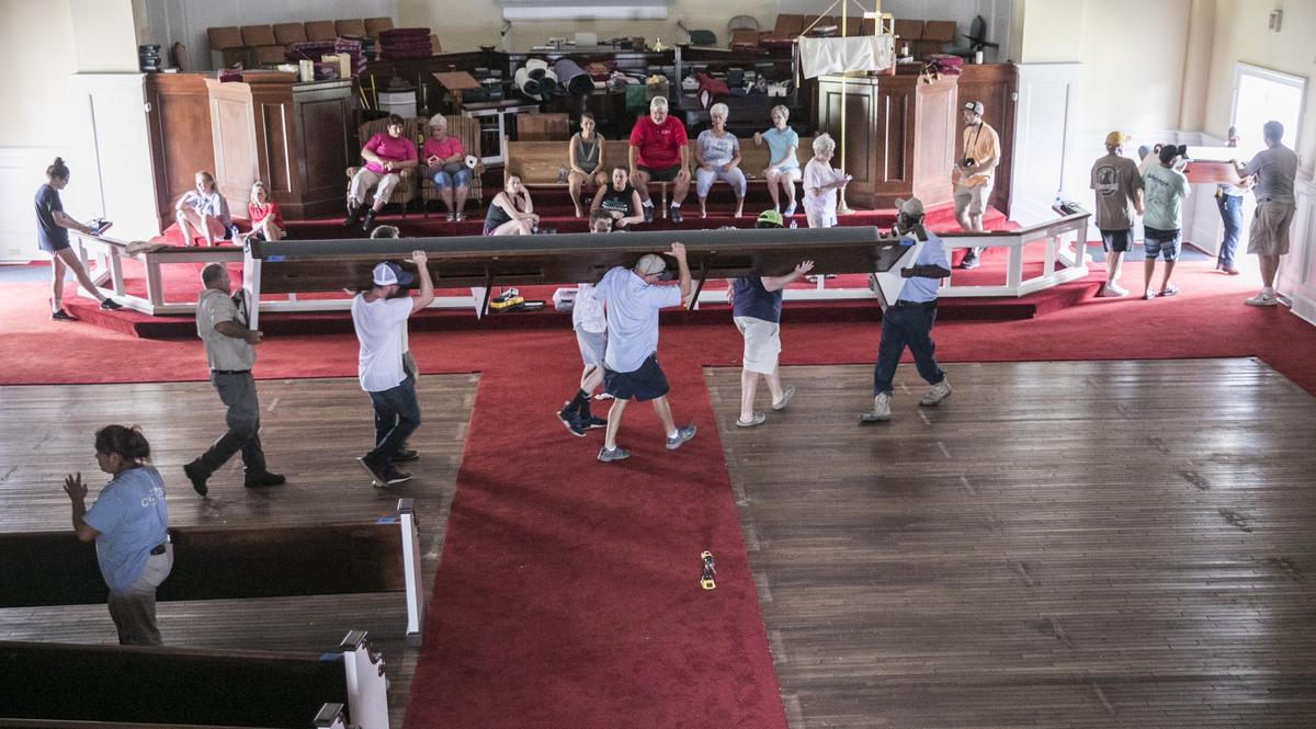 Church members and residents from the local community came together to move the pews and other contents of Trinity United Methodist to higher ground on on Tuesday ahead of what is expected to be record flooding from the Waccamaw River due to Hurricane Florence’s rains. September 18, 2018.