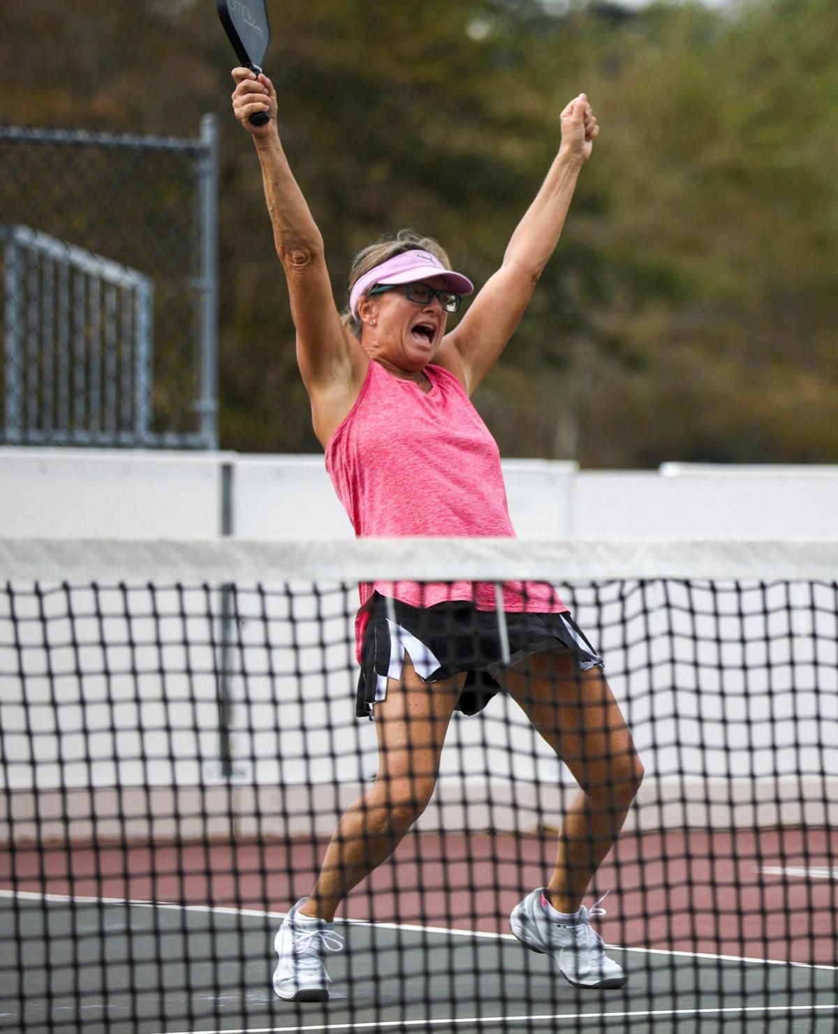 Lynn Palmer celebrates a big point during doubles pickle ball play in Central Park, North Myrtle Beach, S.C. on Tuesday. Pickleball, invented in 1965, is considered America’s fastest growing sport, according to a 2022 report by the Sports and Fitness Industry Association. October 17, 2022.