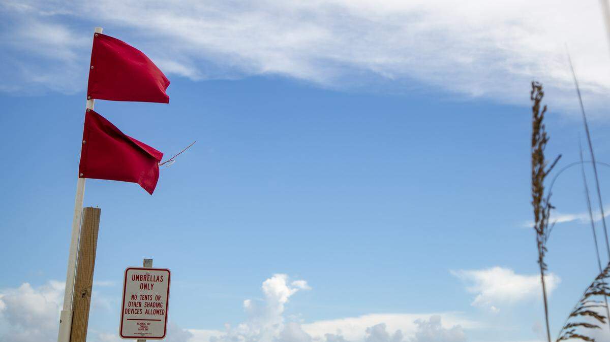 Red flags fly on the beach Tuesday as Hurricane Florence approaches the coast of Myrtle Beach. The storm is expected to make landfall Thursday evening.