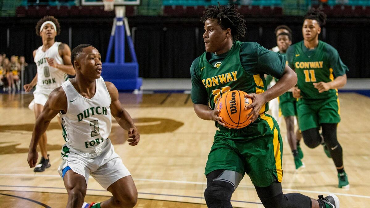 Conway senior forward Tonka Hemingway drives the ball against the Dutch Fork defense during the Class 5A Lower State finals Saturday evening at the Florence Center in Florence, S.C.