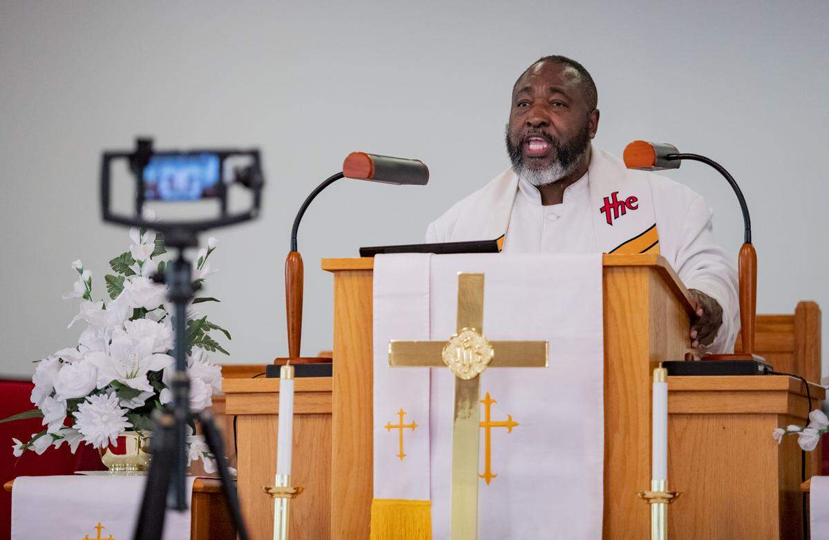 Reverend Johnathan Greene records a sermon on an iPhone Saturday afternoon at St. Paul African Methodist Episcopal Church in Little River. Churches have taken to delivering virtual sermons in an effort to fight the spread of the COVID-19 coronavirus.