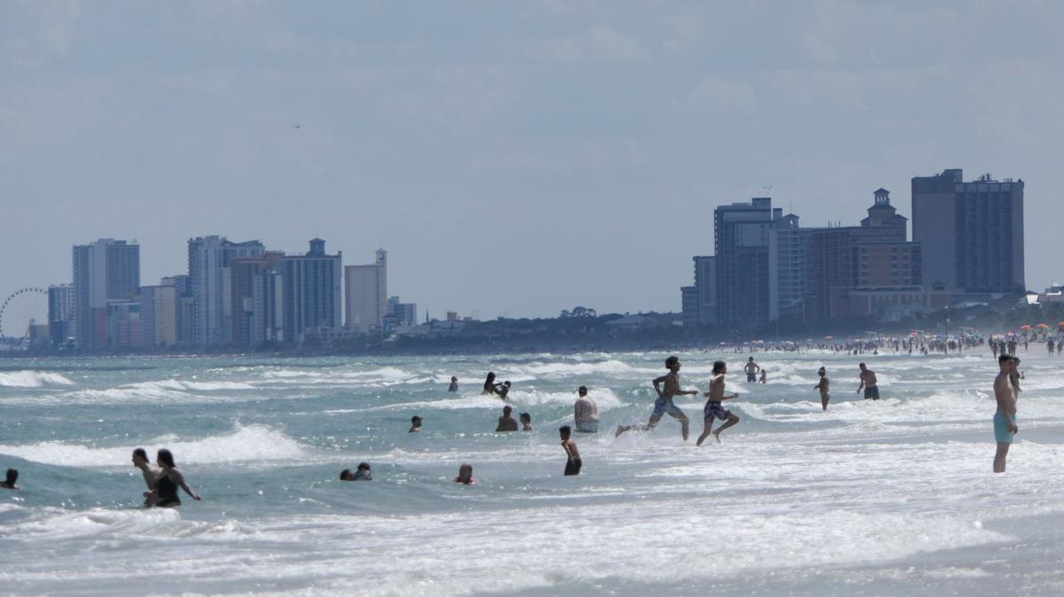 Tourists swim in the Atlantic Ocean with the Myrtle Beach skyline in the background. May 29, 2024.
