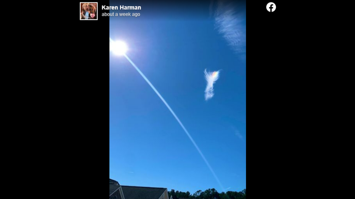 Karen Harman says the cloud appeared in an otherwise cloudless sky over her home in Myrtle Beach, South Carolina, and she managed to get a single photo showing “wings” and a face the color of a rainbow.
