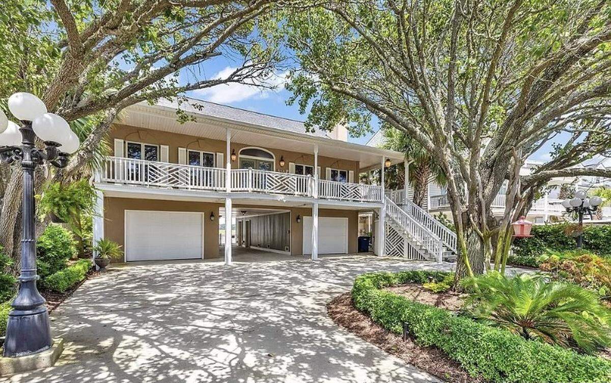 A $1.7 million house is listed for sale on Zillow. The home in North Myrtle Beach is nestled between 30-foot palm trees and features an elevator and dock.