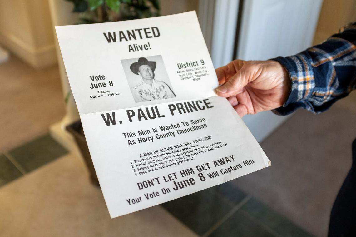 Horry County Councilman Paul Prince holds up an old campaign sign he used during one of his races.