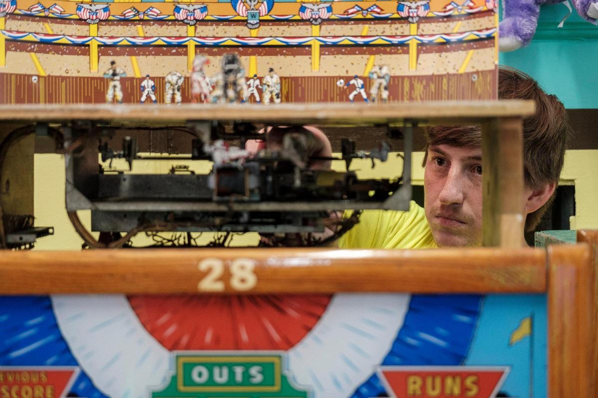 Austin Waldorf, daytime manager of Myrtle Beach’s landmark Fun Plaza arcade, tunes a 1957 William Deluxe Baseball game. Fun plaza maintains 38 of these old machines as well as other classic arcade games. These Myrtle Beach area arcades with their classic games bring back the nostalgia of a bygone era for Grand Strand tourists.July 11, 2022.