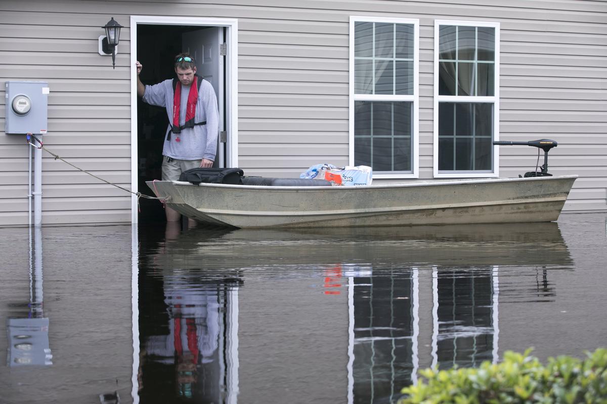 John McGarva, an Horry County firefighter looks over his his flooded home in the Polo Farms neighborhood off S.C.905. After a 36 hour shift with the fire department, McGarva was making pictures of each of his neighbors homes to share on a community facebook page. The Red Bluff community off S.C.905 has flooded along the Waccamaw River and Simpsons Creek under Hurricane Florence’s deluge with entire neighborhoods underwater. Monday, Sept. 24, 2018.