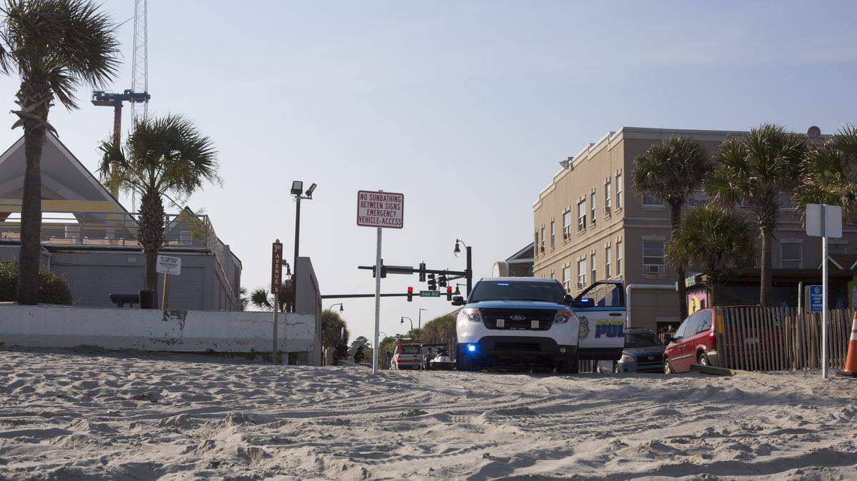 A Myrtle Beach police officer sits at a beach access point after a joint Myrtle Beach Fire Rescue and Myrtle Beach police operation rescued someone from the water near Third Avenue South, according to police Capt. Joey Crosby.
