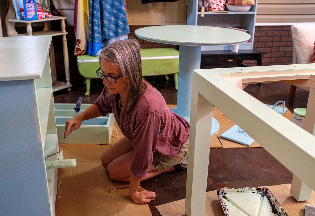 Emily Smith, owner of Good Day Sunshine, paints cases between serving customers. The owner of an aromatherapy retail store in Conway selling handmade soaps and candles, Smith is re-arranging her shop and providing counter service to better maintain social distancing. April 23, 2020