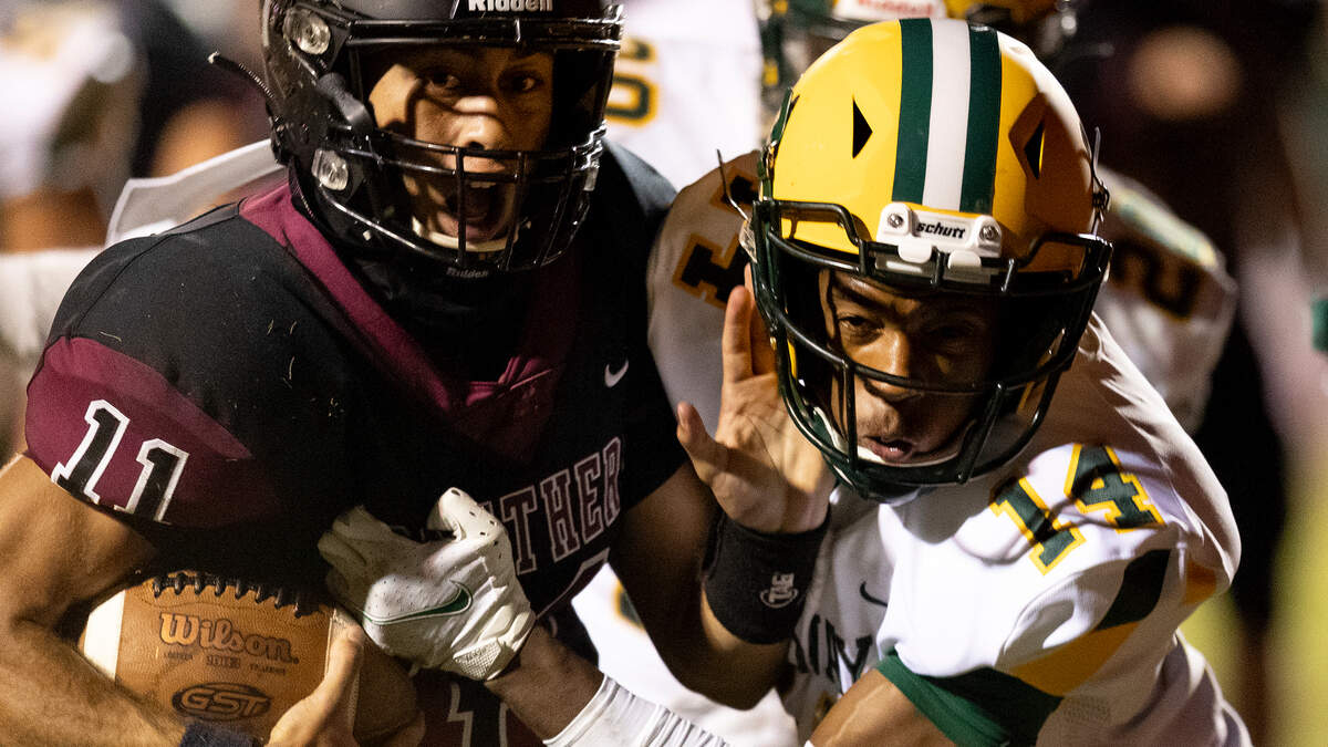 Carolina Forest QB Kyle Watkins (11) edges past Conway’s defensive back Ty’lyan Sarvis for a touchdown during 2nd quarter action Friday at Carolina Forest High School.