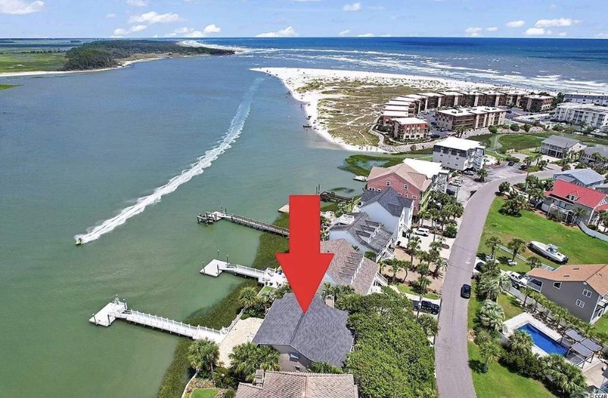 A $1.7 million house is listed for sale on Zillow. The home in North Myrtle Beach is nestled between 30-foot palm trees and features an elevator and dock.