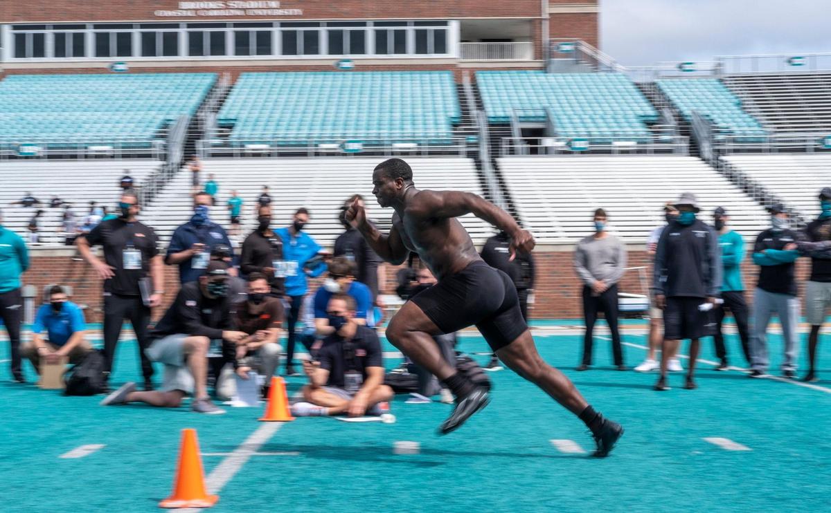 Coastal’s Tarron Jackson runs drills in front of NFL scouts at the Coastal Carolina Pro Day on Tuesday at Brooks Stadium in Conway, S.C. Defensive end Tarron Jackson, who received an invitation to the NFL Combine that is not being held because of the coronavirus, and running back C.J. Marable were among the participants. March 23, 2021.