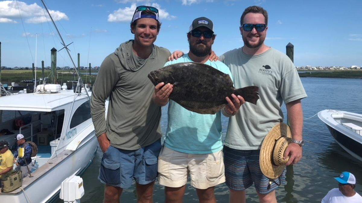 Brunson Miller, Dennis Lee Smith and Chase Limehouse show off the 7.25-pound, 26.5-inch flounder that won the 15th annual Rotary Flounder Tournament last Saturday at Crazy Sister Marina.