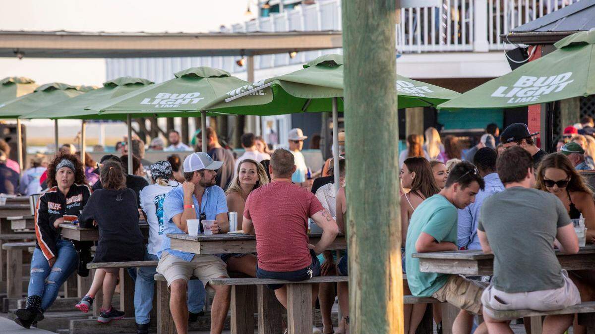 Diners gather around local restaurants at the Murrells Inlet Marsh Walk. With hotels, beaches, shopping and restaurants reopening along the Grand Strand, tourist season kicked off this weekend despite coronavirus concerns. May 16, 2020