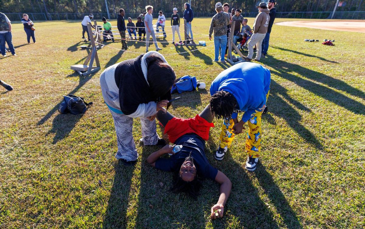 Tavon Calhoun collapses to catch his breath after a three round fight at Bayboro Park in Aynor, S.C. Carolina Fight Club with the motto of “Guns “down, gloves up” was founded by Nate Jenkins and four friends in 2019, as a way to safely settle differences and hone the craft of boxing. The matches, open to anyone who wants a fair fight, are held in backyards and community parks in rural Horry County, S.C. Nov. 23, 2024.