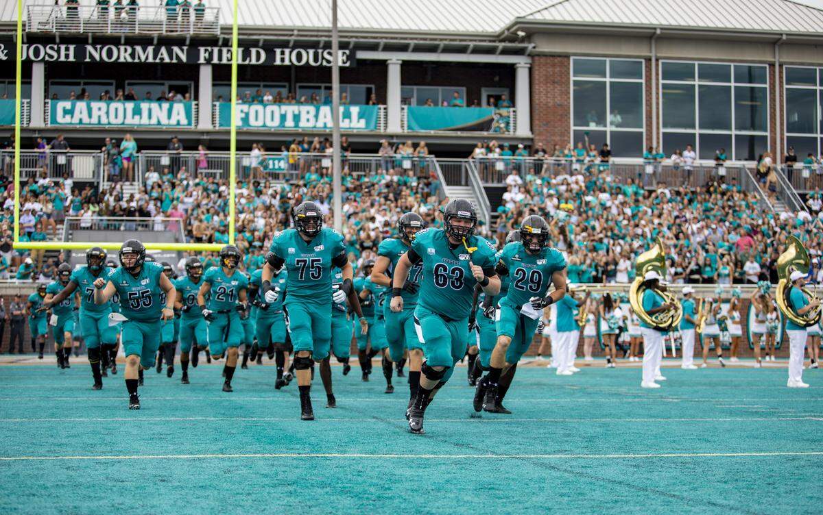 The Coastal Carolina Chanticleers take the field before the start of their opening game of the 2019 season against Eastern Michigan on the ‘Surf Turf’ at Brooks Stadium in Conway.