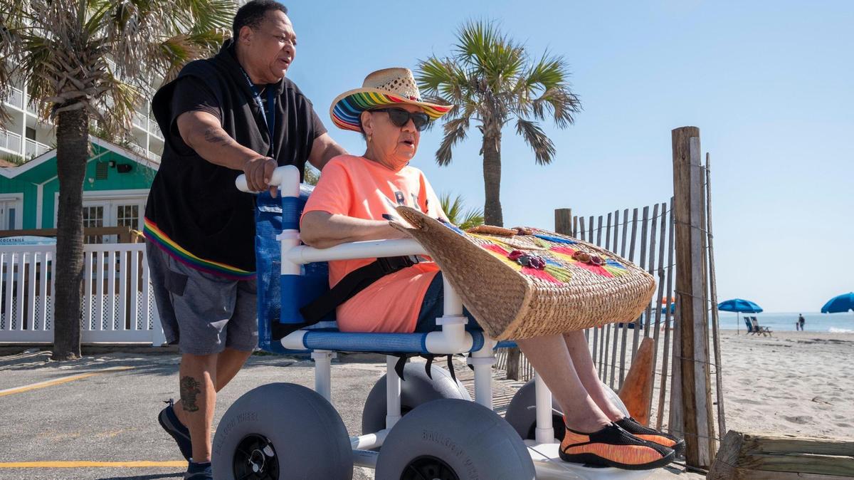 Unita Knight takes her mother, 90-year-old Joan Pulliam, to their favorite beach access in wheelchair to have her their portraits made. Knight purchased the specialized chair for almost $1,000 to be able to take her mother to the beach after the City of Myrtle Beach discontinued providing beach wheelchairs.April 19, 2023.