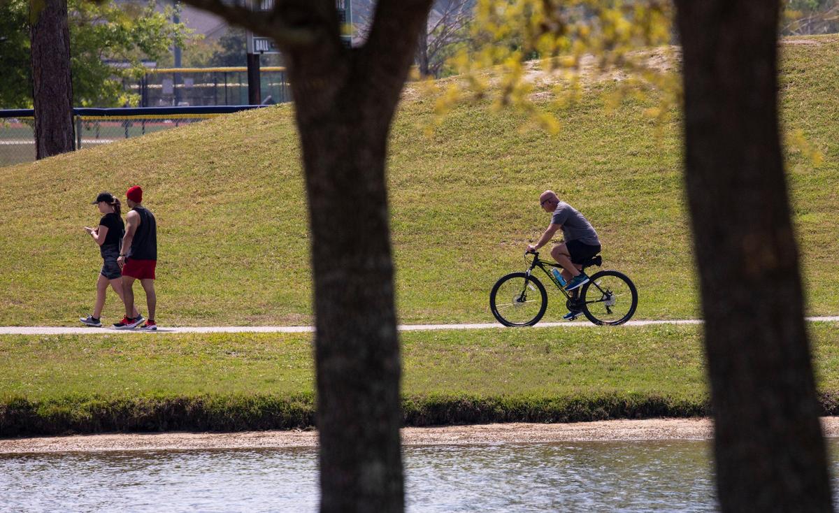 Bikers and walkers use the path around Market Common’s Grand Lake on Tuesday. Locals around the Grand Strand were enjoying the Spring weather on Tuesday by getting outside. South Carolina’s Governor Henry McMaster toughed his “work or stay home” order this week In response to the coronavirus, but he made allowances for recreational activities. April 7, 2020