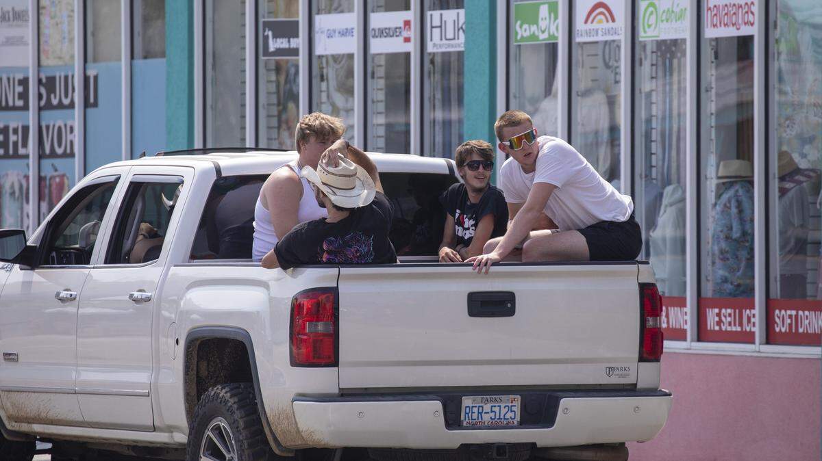 Teens ride in the back of a pick-up truck in North Myrtle Beach, S.C. June 9, 2023. 