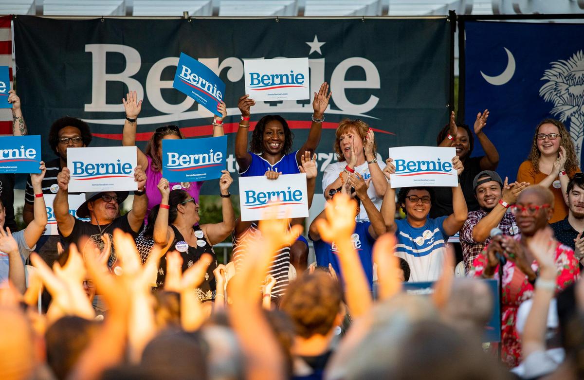 Bernie Sanders supporters sit onstage at Chapin Park before the start of a Bernie Sanders rally Thursday evening. Sanders made a stop in Myrtle Beach to talk about climate change.