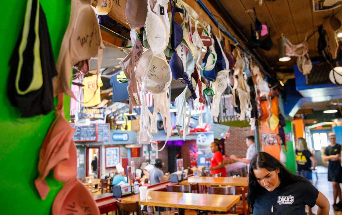 Women’s bras hang from the ceiling of Dick’s Last Resort at Barefoot Landing in North Myrtle Beach, a theme restaurant where visitors can expect light hearted jokes from the staff. The first Dick’s Last Resort opened in Dallas in 1985. The Barefoot Landing location opened in 1992 and today the chain has 12 locations around the country. Aug. 12, 2024.
