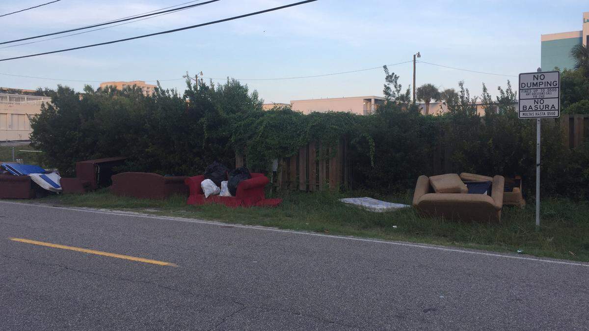 Couches sit along Yaupon Drive between 15th Avenue South and 16th Avenue South next to a no dumping sign.