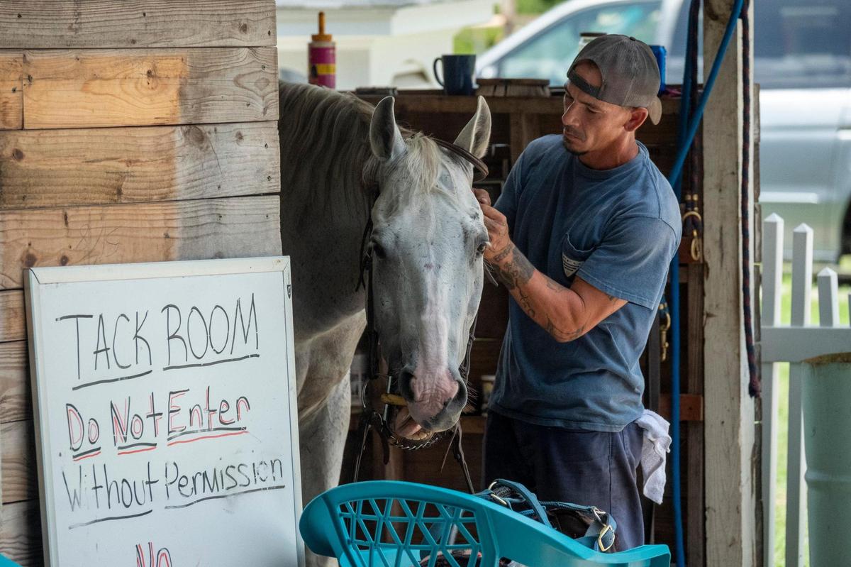 A resident of Recovery Ranch care for horses on the property. Recovery Ranch, a living facility for those struggling with homelessness, mental illness and drug addictions has come under fire by county officials for code violations and the volume of 9-11 calls. According to the founder, the facility could be shut down leaving approximately 75 residents with no where to go. July 1, 2021.