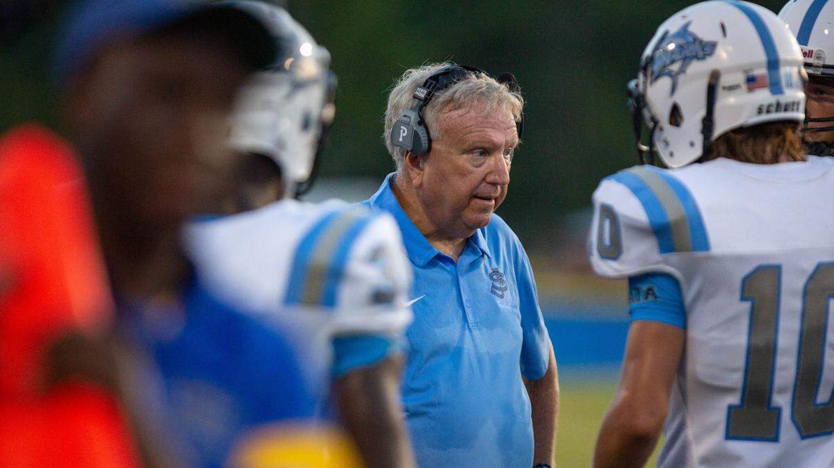St. James Sharks head coach Tommy Norwood talks to his players against the Loris Lions Friday night at Heniford Field in Loris.