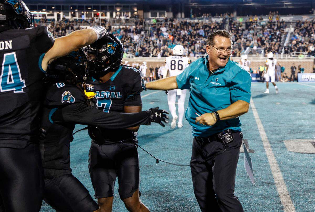 Coastal’s head coach Tim Beck celebrates an interception. The Coastal Carolina Chanticleers beat the Appalachian State Mountaineers 38-24 in front of the second-biggest Brooks Stadium crowd of the season on Thursday night. November 7, 2024.