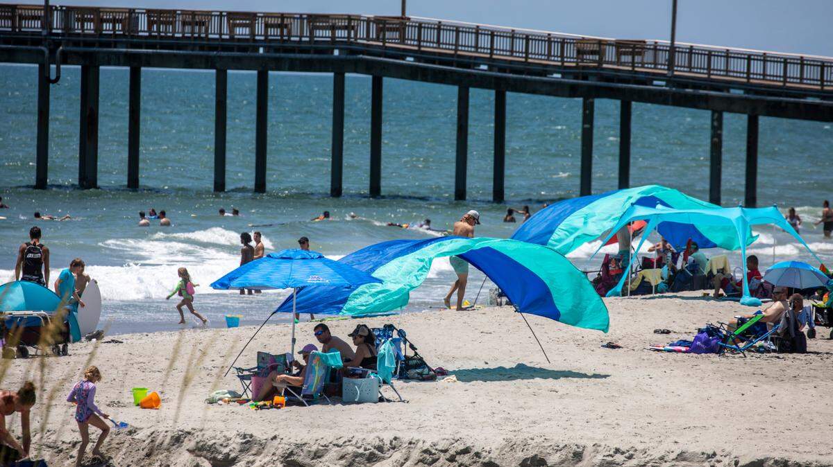 Shibumi Shades are set up near the Springmaid Pier in Myrtle Beach. In the summer heat of July, Myrtle Beach area residents and tourist look to the water for relief. With waterparks, jet ski rentals, parasails, banana boat rides, paddle boards and kayaks, there are plenty of options to beat the heat. July 5, 2022.