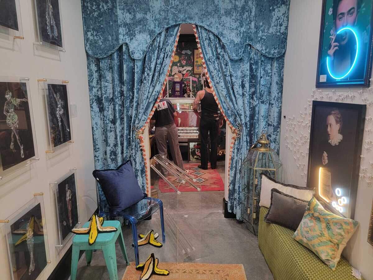 A corridor displays art on sale at Room Service.