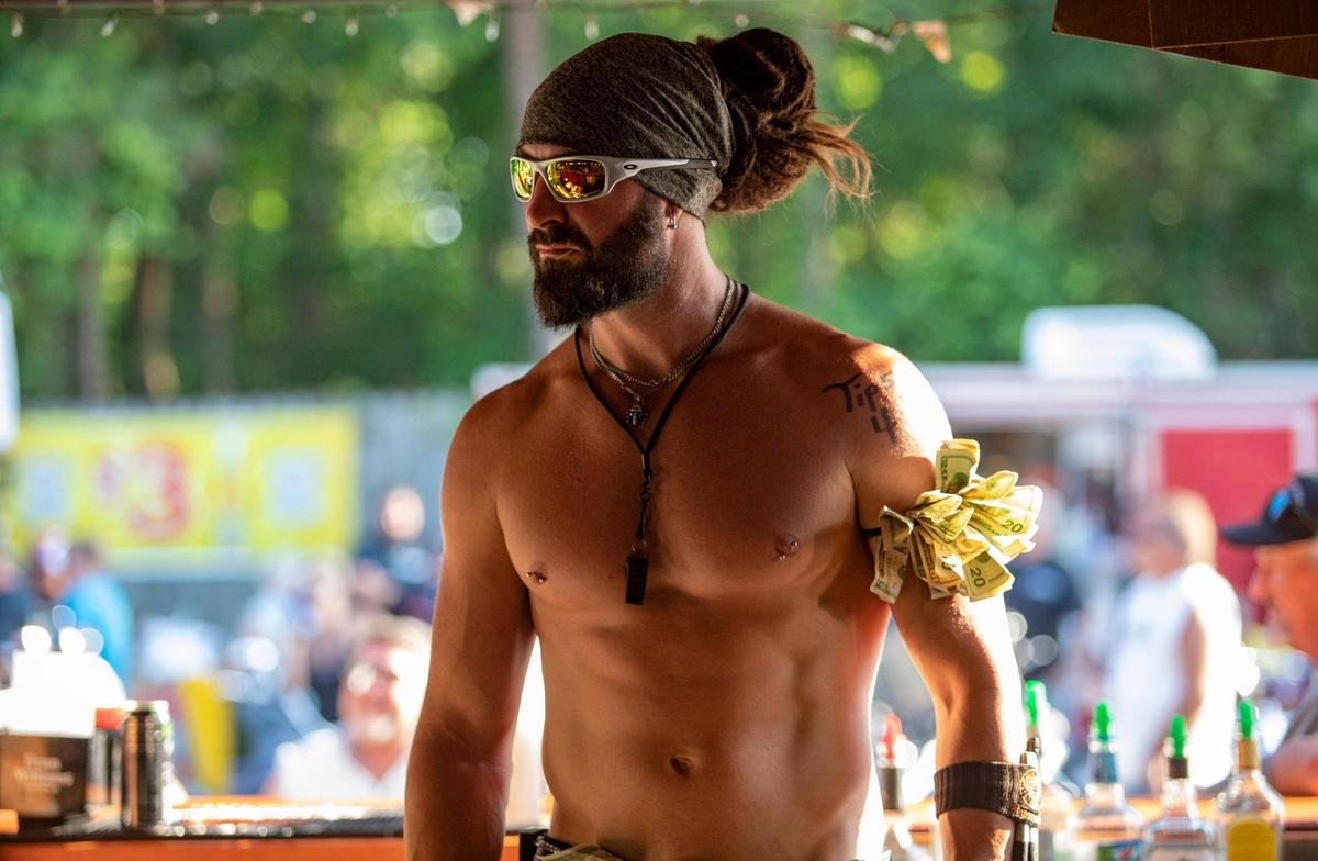 Bartender Sloan Gasior of Wisconsin works behind a bar at Suck Bang Blow Friday afternoon during Bike Week in Murrells Inlet.