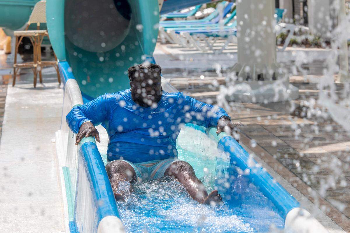 Isaiah Stephens of Johnson City, TN emerges from a slide with water spraying at the H2oasis waterpark at the Landmark Resort.