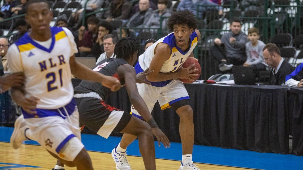 North Little Rock (AR) senior guard Collin Moore holds the ball against Florence (MS) in the 2018 Beach Ball Classic Wednesday at the Myrtle Beach Convention Center. The 38th annual Beach Ball Classic holiday high school basketball tournament tipped off Wednesday at the Myrtle Beach Convention Center. North Little Rock (Arkansas) defeated Florence (Mississippi) 76-60 in the opening game behind 19 points from senior Shawn Fudge. Alabama commitment Jaylen Forbes had a double-double for Florence with 27 points and 17 rebounds. The tournament features 16 teams from throughout the country and games continue daily through New Year’s Eve with the exception of Sunday, when dunk and 3-points contests will be held beginning at 6:30 p.m.