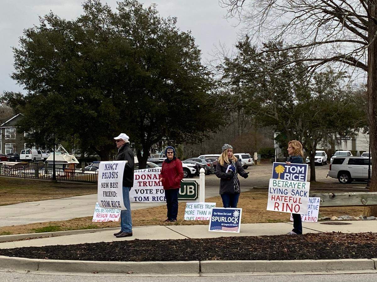 A handful of protesters greet U.S. Rep. Tom Rice at a town hall in Conway, in January 2022.