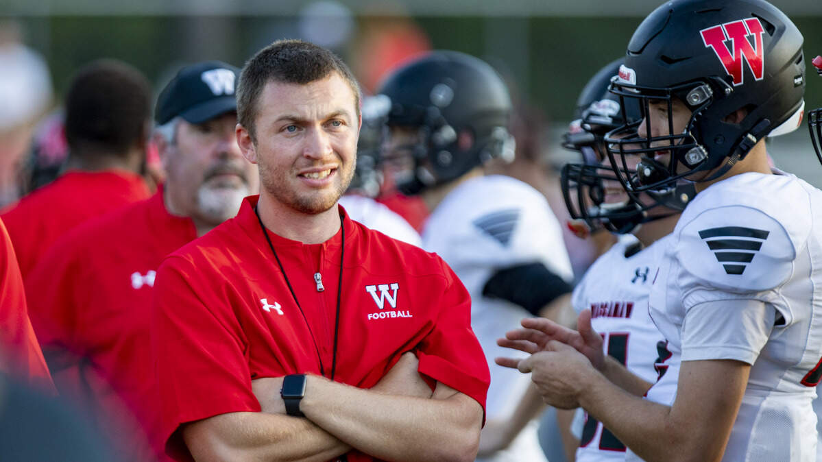 Waccamaw head football coach Shane Fidler watches as his players warm up before the start of the Warriors’ game against the Aynor Blue Jackets on Aug. 30 in Aynor. Waccamaw and Georgetown will move into a Class 3A region with Aynor, Loris and Dillon under a proposed realignment of S.C. high schools.