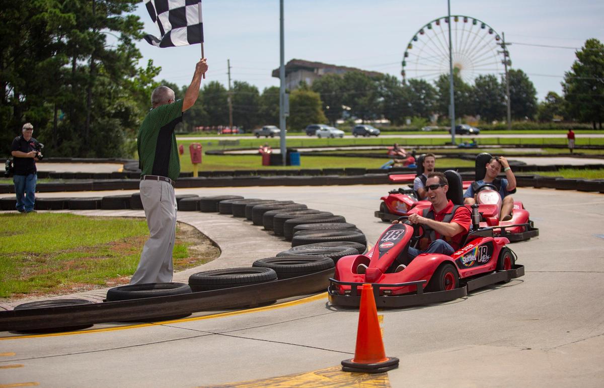 NASCAR driver and current points leader Kyle Busch races fans on a go-kart track at Broadway Grand Prix in Myrtle Beach on Aug. 7. Busch was in Myrtle Beach for the Grand Opening of the PALM Charter School in Conway.
