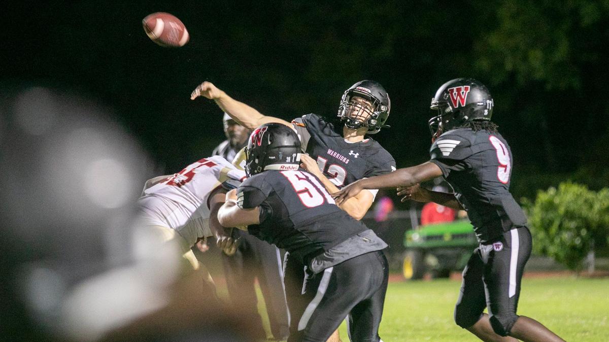 Waccamaw’s Kam Green throws a touchdown pass to Tyree Funnye against Carver’s Bay. Waccamaw High School hosted Carver’s Bay in the first football game of the regular season.