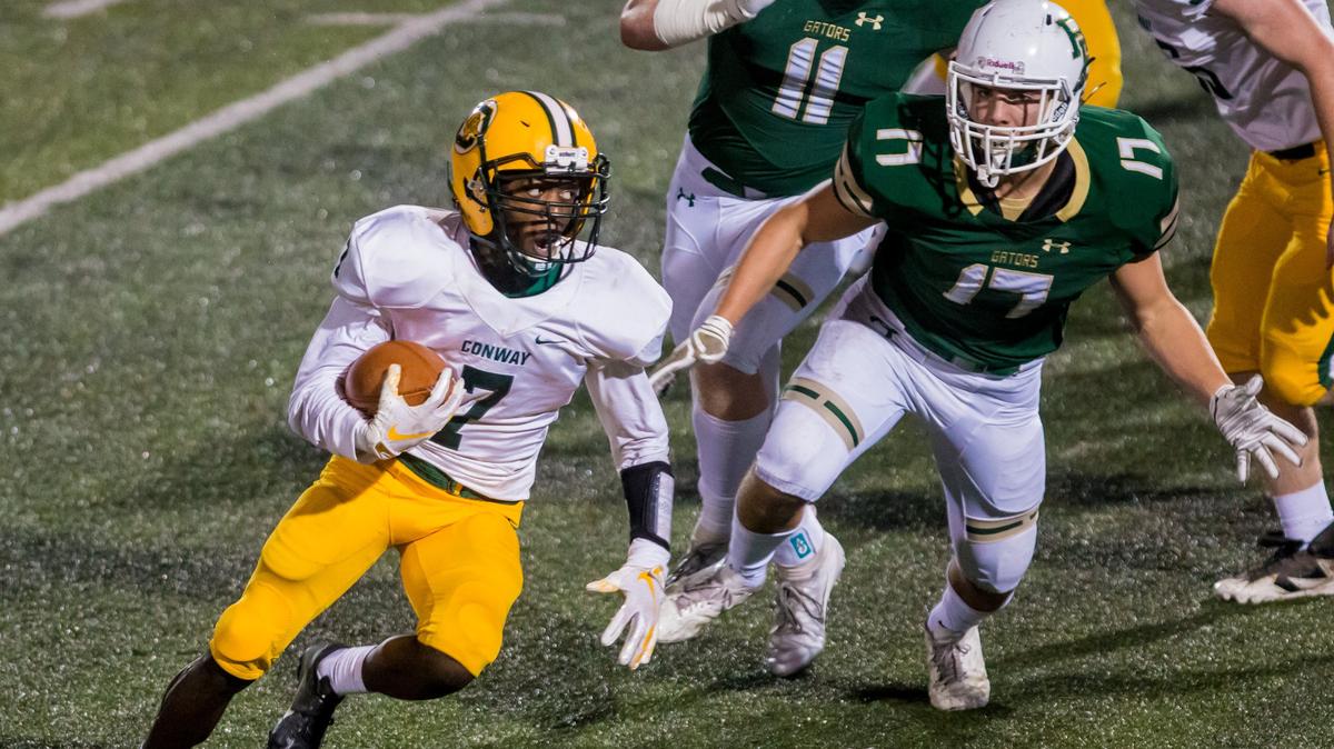 Conway Tigers Xavier Kinlaw (7) rushes against the River Bluff Gators during their playoff game at River Bluff High School.