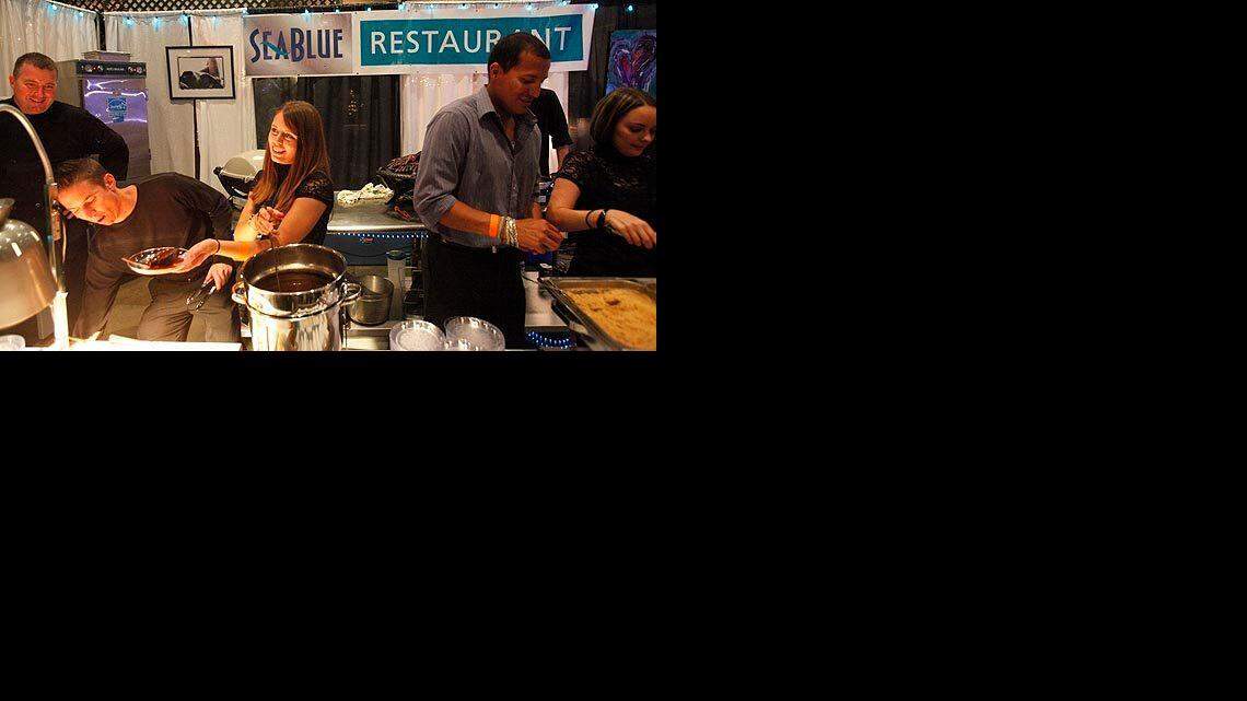 10-27-09/Tuesday-----Servers at the SeaBlue Restaurant booth take orders Tuesday during the 2009 Taste of the Town benefit at the Myrtle Beach Convention Center.


Photo By Randall Hill
rhill@thesunnews.com