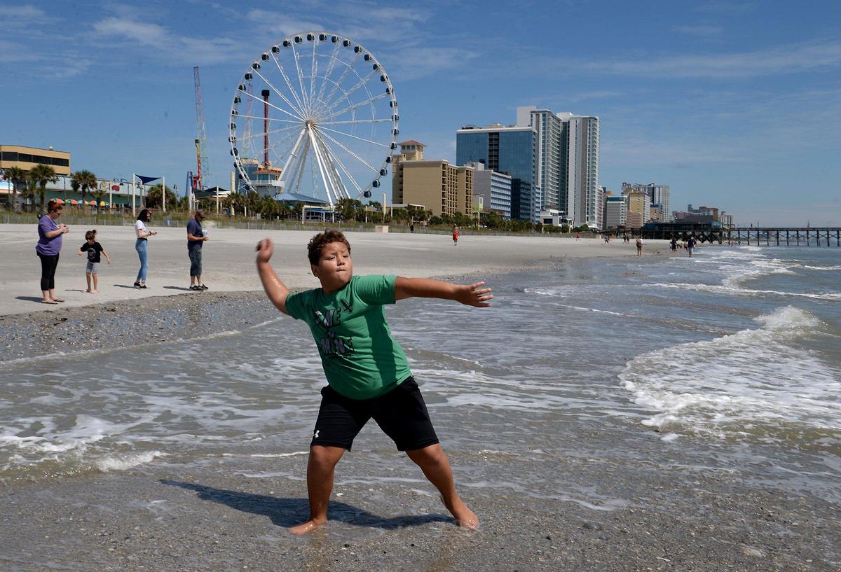 Myrtle Beach, SC area resident Ray Ray Dorty throws rocks and seashells into the water along Myrtle Beach following Hurricane Dorian on Friday, September 6, 2019.