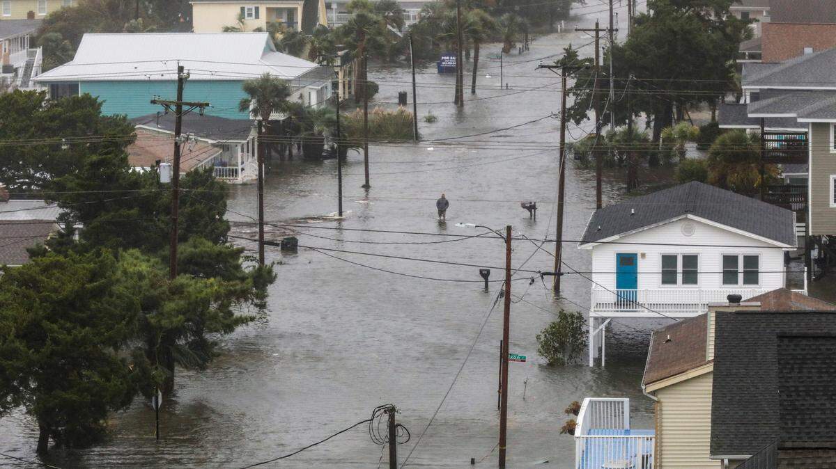 A North Myrtle Beach resident walks through flood waters as Hurricane Ian’s storm surge inundates the area. Conditions deteriorated throughout the day on Friday in North Myrtle Beach as Hurricane Ian made landfall near Georgetown, S.C. The Cherry Grove area experienced severe flooding due to Ian’s storm surge on Friday, September 30, 2022.