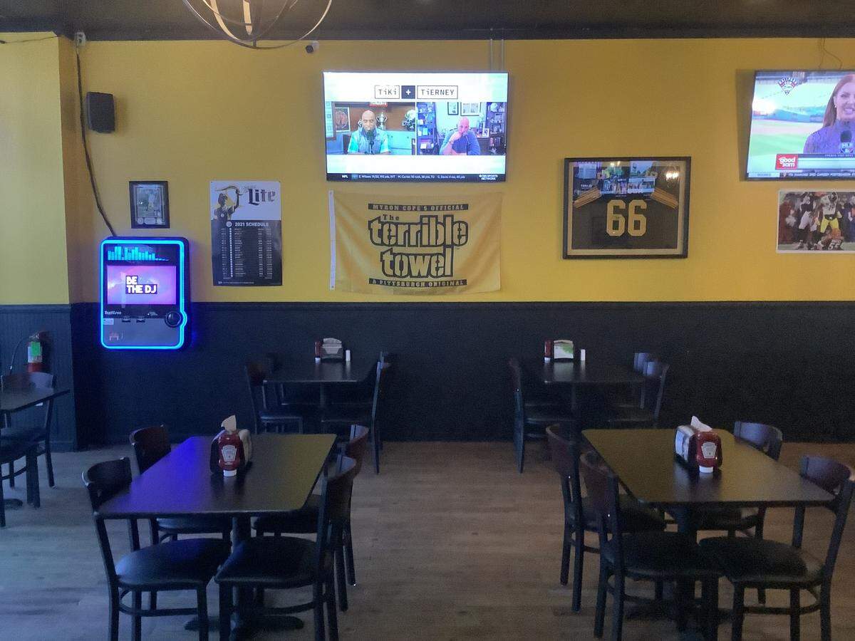 Pittsburgh Steelers jerseys signed by JuJu Smith-Schuster and Alan Faneca are among the memorabilia on the walls of the Blitzburgh sports bar in Murrells Inlet.