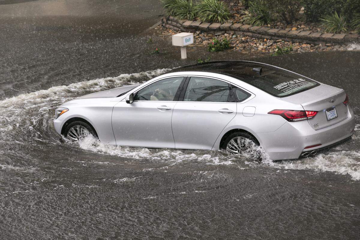 A car drives through flood waters in the Crescent Beach section of North Myrtle Beach. The effects of Hurricane Florence begin to come ashore in North Myrtle Beach, S.C. on the morning of Friday, September 14, 2018.