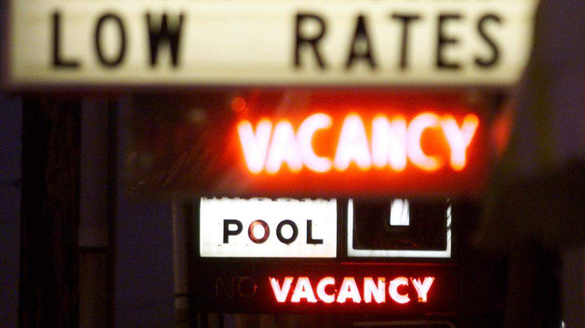 Signs at the Sea Dip and Court Capri, rear, advertise vacancies and low rates for winter guests Wednesday night. Photo taken in January 1999.