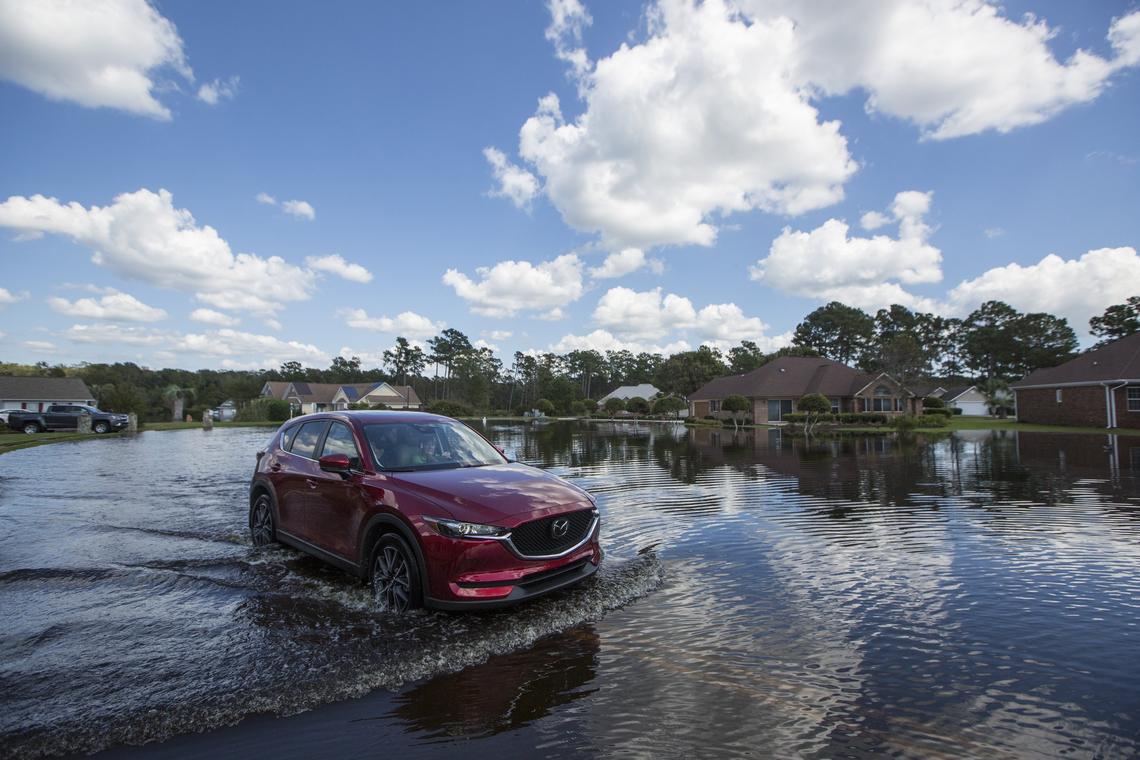 Residents of Aberdeen Country Club leave the area after floodwaters hit the area hard overnight.